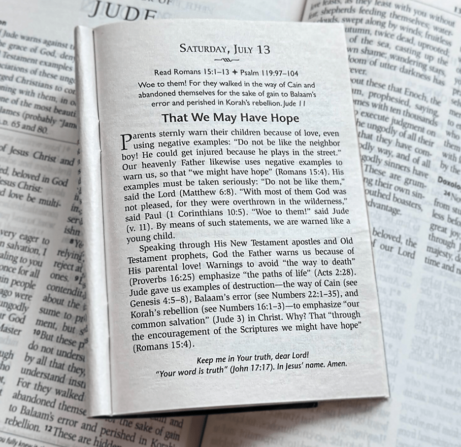 Devotion open laid on top of Portals of Prayer Bible