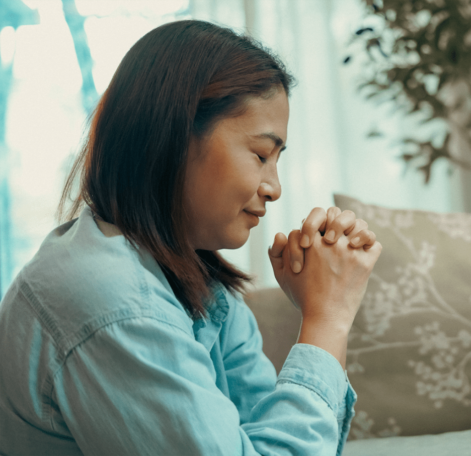Woman folding hands in prayer